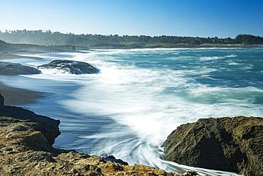 Waves softened by a long exposure surge onto the beach at MacKerricher State Park and Marine Conservation Area near Cleone in Northern California, Cleone, California, United States of America