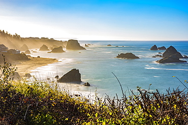 Morning mist rising from Harris Beach, near Brookings, Oregon. The rock formations add to the views looking out at the Pacific Ocean, Oregon, United States of America