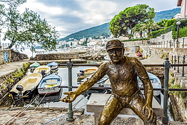 Fisherman sculpture with coins in it's hand in a harbour, Opatija, Primorje-Gorski Kotar County, Croatia