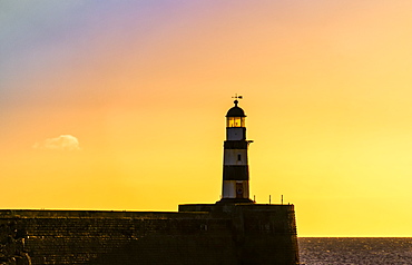 Lighthouse with golden sky at sunset, Seaham, Durham, England