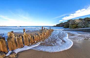 Foam and surf on a beach along the Atlantic coast, South Shields, Tyne and Wear, England