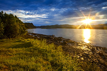 Sun going down on the Yukon River in summer, Alaska, United States of America