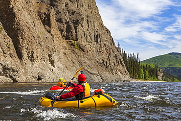 Two women packrafters negotiating a tributary of the Charley River in summertime, Yukon–Charley Rivers National Preserve, Alaska, United States of America