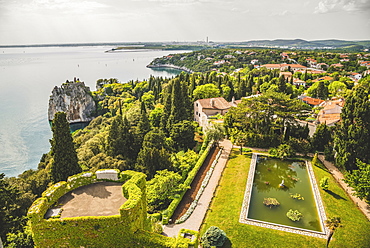 Landscaped grounds of Duino Castle and a view of the coastline of the Gulf of Trieste, Italy