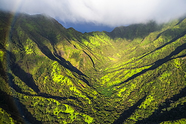 Aerial image of the lush mountains surrounding Oahu with a rainbow in the foreground, Oahu, Hawaii, United States of America