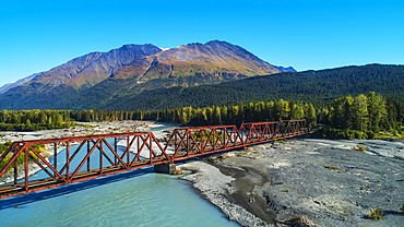 An aerial scenic of the Alaskan Railroad trestle crossing the Snow River on a sunny summer day in South-central Alaska, Alaska, United States of America