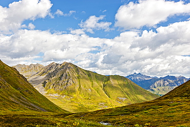 Mountains covered in green tundra on a sunny day in Hatcher Pass, South-central Alaska, Palmer, Alaska, United States of America