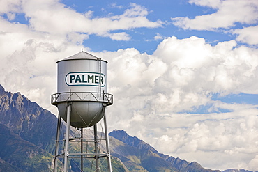 Downtown Palmer water tower, cloudy skies and the Chugach Mountains in the background, South-central Alaska,, Palmer, Alaska, United States of America