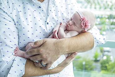 A father holds a newborn baby, Surrey, British Columbia, Canada