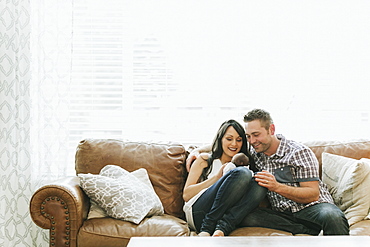 Parents spending time at home with a newborn baby girl, Surrey, British Columbia, Canada