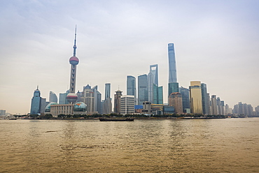 Pudong skyline with its landmark skyscrapers seen from the opposite side of the Huangpu river, Shanghai, China