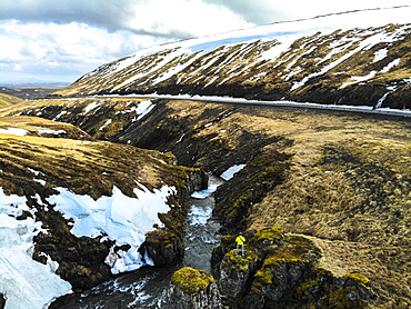 Man observing river next to road in Iceland. Image taken with a drone, Grundarefjorour, Iceland