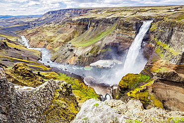 A high viewpoint of one of the waterfalls and rivers in the Haifoss valley with stunning cliffs, natural colors and rock formations, Iceland