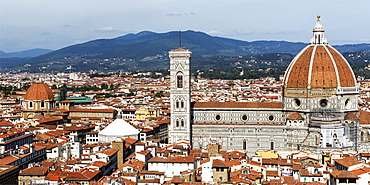 Panorama of the city of Florence with Florence Cathedral, it's dome and bell tower, and mountain range in the background, Florence, Tuscany, Italy