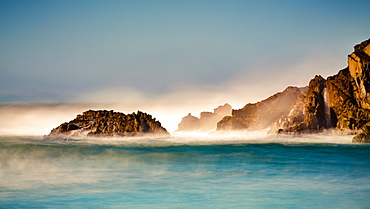 Mist over the turquoise water along the rugged coastline, Big Sur, California, United States of America