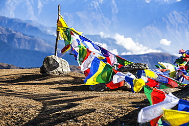 Buddhist prayer flags at the summit of Pikey Peak in the Himalayas, Nepal