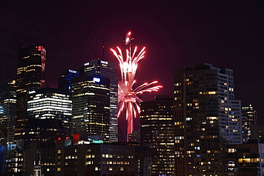 Red fireworks in the night sky in front of the CN tower, Toronto, Ontario, Canada