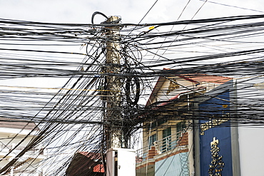 Lamppost with numerous wires and cables, Phnom Penh, Cambodia