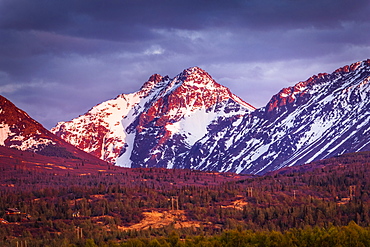 Sunset glows on Ptarmigan Peak in Chugach Mountains, South-central Alaska in spring, Alaska, United States of America