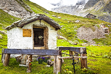 A small, historic shrine at Val Veni with Rifugio Elisabetta in the background, Alps, Aosta Valley, Italy