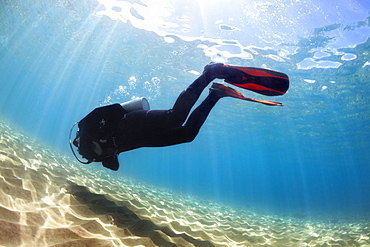 A male scuba diver in bright blue water, Makena, Maui, Hawaii, United States of America