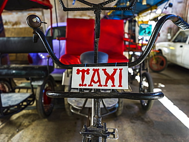 Cycle rickshaw with taxi sign, Havana, Cuba