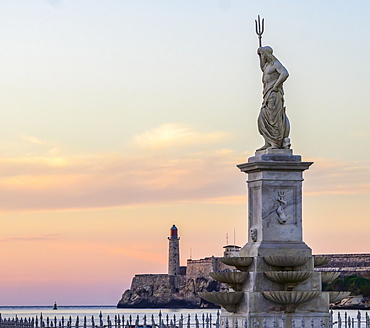 Morro Castle at sunset, with a statue of Poseidon with trident in the foreground, Havana, Cuba