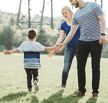 A family with young son playing in a park, Edmonton, Alberta, Canada