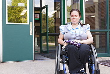 Student in wheelchair with Spina Bifida exiting the school