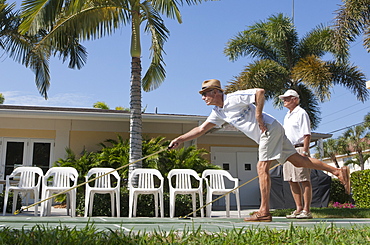 Senior men playing shuffleboard