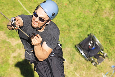 Man with spinal cord injury mountain climbing with adaptive equipment