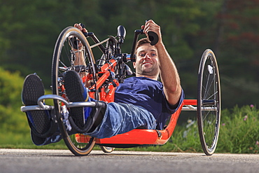 Man with spinal cord injury on his custom adaptive hand cycle