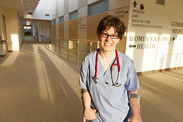 Nurse with Cerebral Palsy walking down the hallway of a clinic with her canes