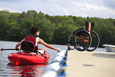 Woman with a Spinal Cord Injury learning how to use a kayak