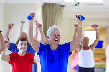 Senior people exercising in gym