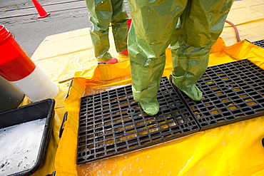 HazMat firefighter getting decontamination wash