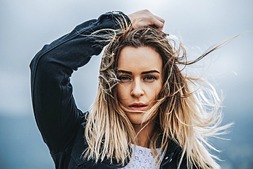 Portrait of a beautiful young woman with windblown hair; Wellington, North Island, New Zealand