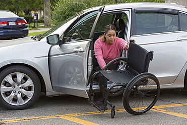 Woman with Spinal Cord Injury getting out of her car