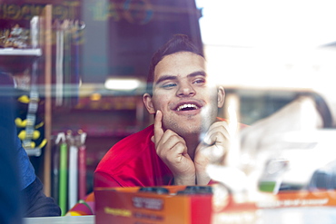 Middle Eastern man with Down Syndrome smiling at work