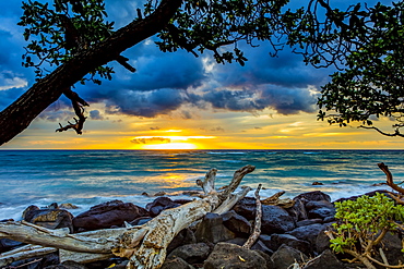 Sunrise over the Pacific Ocean from the shore of Lydgate Beach; Kapaa, Kauai, Hawaii, United States of America