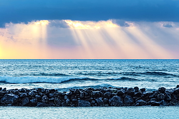 Sunrise over Lydgate Beach and the ocean from the coast of Kauai with a breakwater; Kapaa, Kauai, Hawaii, United States of America