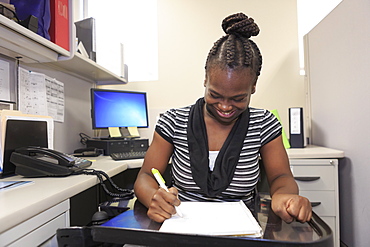 Teen with Cerebral Palsy working in an office