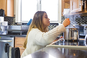 Woman with Spinal Cord Injury cooking in the kitchen