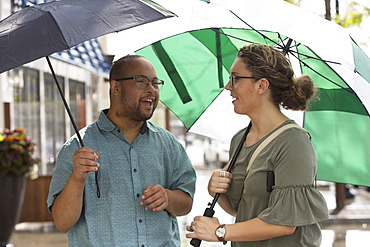 Man with Down Syndrome and friend in rain