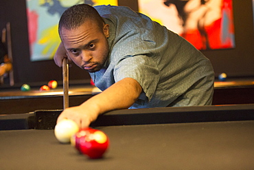 Man with Down Syndrome playing pool