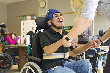 Boy with Spastic Quadriplegic Cerebral Palsy using using his helmet and strap