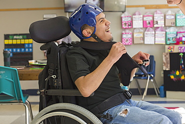 Boy with Spastic Quadriplegic Cerebral Palsy using using his special needs helmet