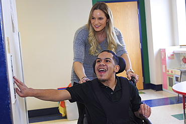 Boy with Spastic Quadriplegic Cerebral Palsy using elevator at school