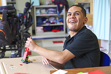 Boy with Spastic Quadriplegic Cerebral Palsy learning at school