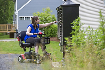 Young Woman with Cerebral Palsy getting the mail